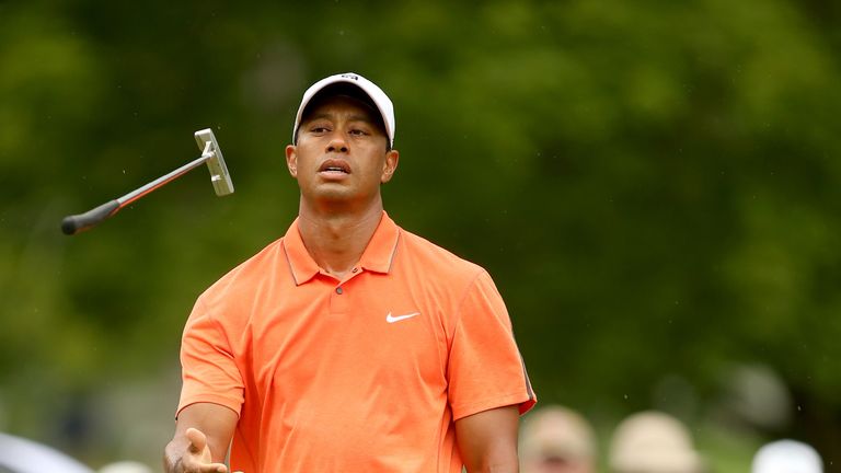 Tiger Woods reacts to a missed birdie putt on the fourth hole during the third round of the Greenbrier Classic