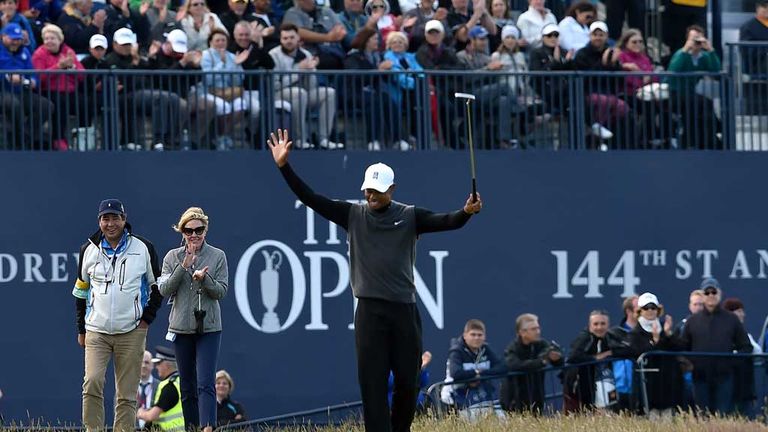 Tiger Woods celebrates making his birdie at the Road Hole during the Champion Golfers' Challenge at St Andrews