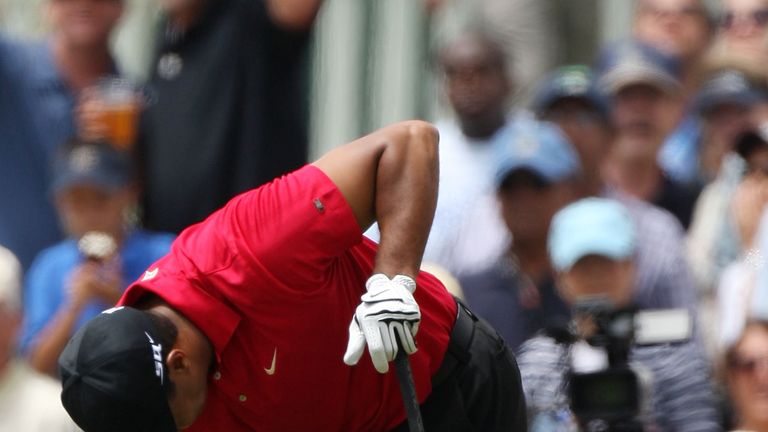 Tiger Woods clutches his knee during the final round of the 108th U.S. Open