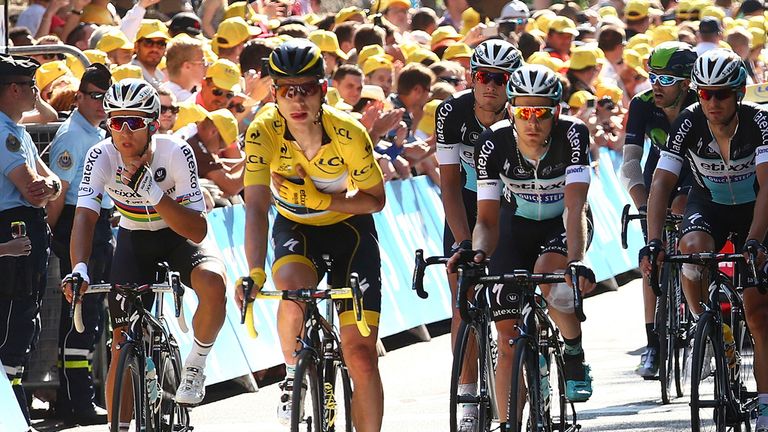 Germany's Tony Martin holds arm in a position which could indicate a broken collar bone 