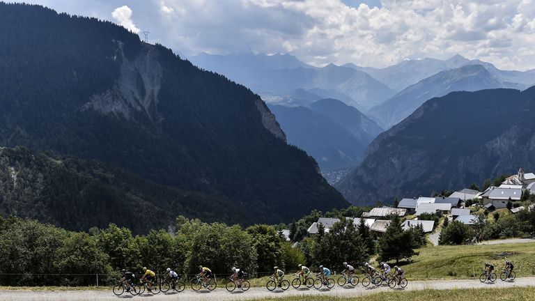 Great Britain's Christopher Froome (2ndL), wearing the overall leader's yellow jersey, rides in the pack during the 138 km 