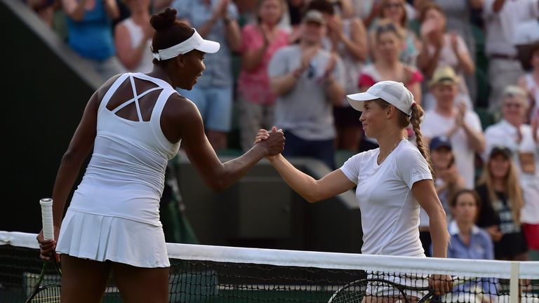 Venus Williams (L) shakes hands with Yulia Putintseva at Wimbledon