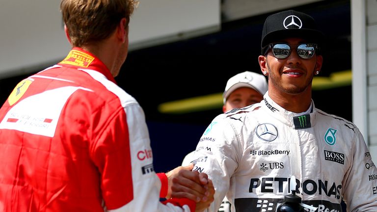 Lewis Hamilton is congratulated on his pole position by Sebastian Vettel
