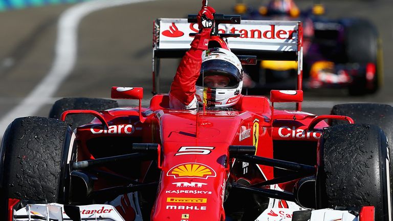 Sebastian Vettel celebrates as he approaches Parc Ferme after winning the Hungarian GP