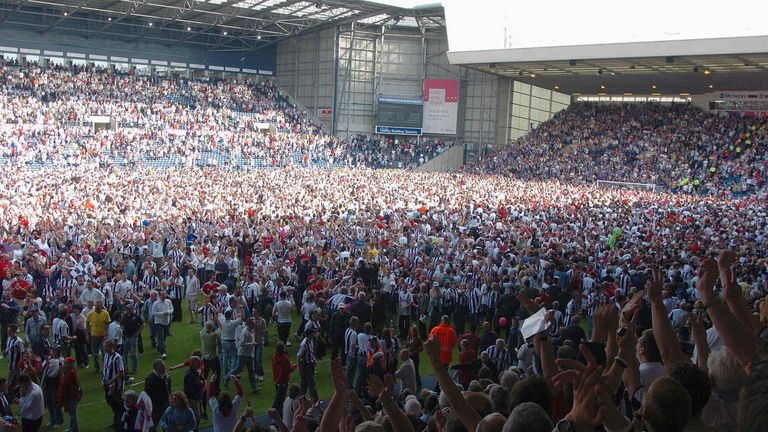 West Brom fans celebrated on the pitch after beating Portsmouth 2-0