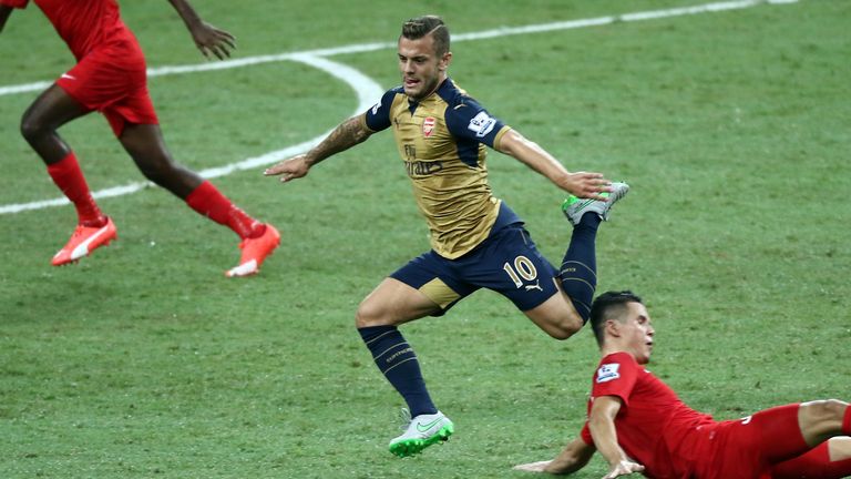 Jack Wislhere of Arsenal skips past a Singapore Select XI midfielder