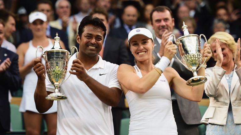 Leander Paes of India and Martina Hingis of Switzerland celebrate with the trophy after winning the Final Of The Mixed Doubles 