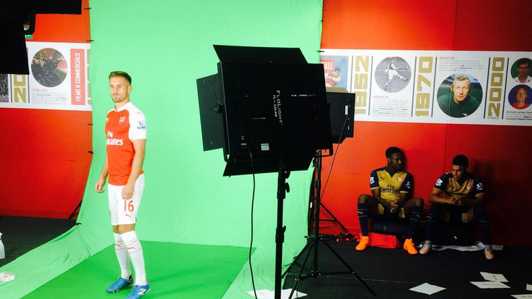 Arsenal's Aaron Ramsey filming pre-match graphics for Sky Sports. Danny Welbeck and Alex Oxlade-Chamberlain in background