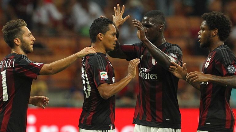 Carlos Bacca (2nd L) of AC Milan ccelebrates with his team-mates after scoring the opening goal during the Serie A match between