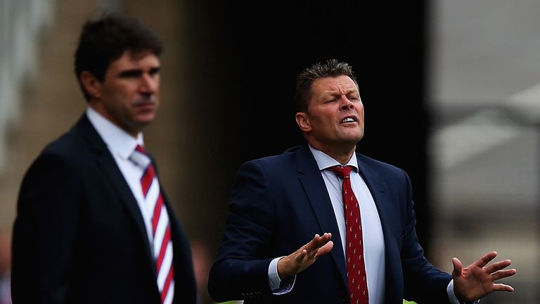 Steve Cotterill, manager of Bristol City gives out instructions, as Aitor Karanka looks on