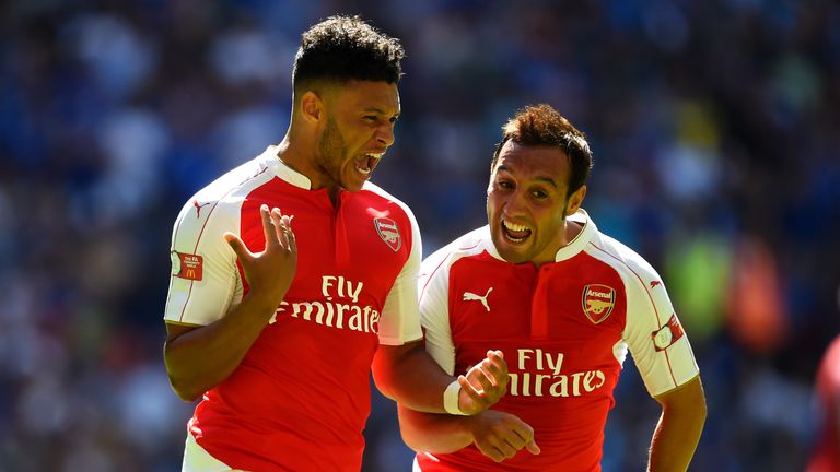 LONDON, ENGLAND - AUGUST 02:  Alex Oxlade-Chamberlain (L) of Arsenal celebrates scoring his team's first goal with his team mates Santi Cazorla (R)  during