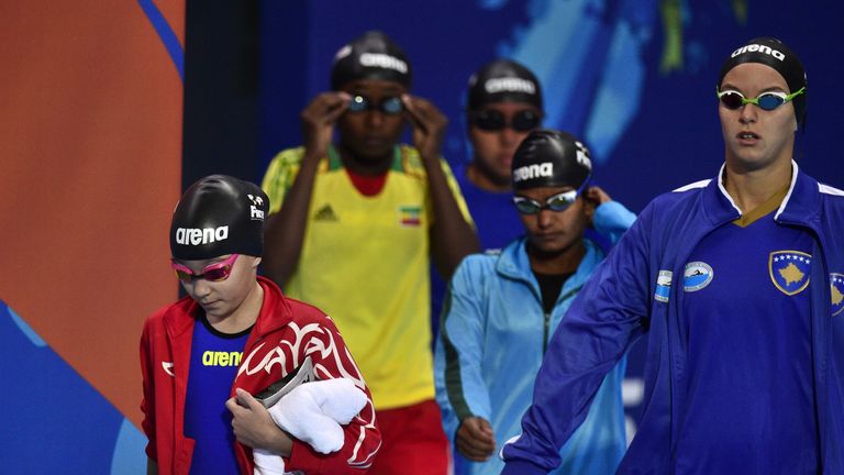 Little Alzain (left) arrives to compete in the preliminary heats of the women's 50m butterfly