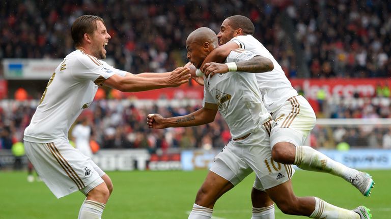 Andre Ayew celebrates with Ashley Williams and Gylfi Sigurdsson 