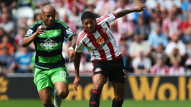 Andre Ayew of Swansea City and Patrick van Aanholt of Sunderland compete for the ball 