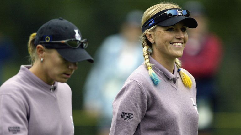 Annika Sorenstam and Carin Koch smile as they walk down the fairway.