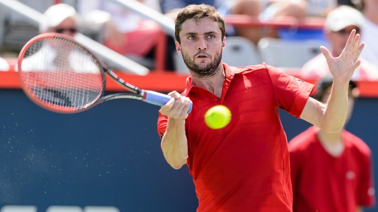  Gilles Simon of France hits a return against Andreas Seppi of Italy during day one of the Rogers Cup