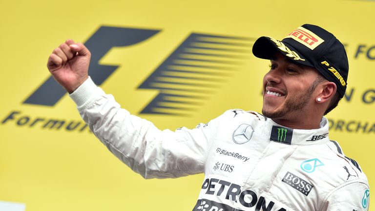 Lewis Hamilton celebrates winning  on the podium 