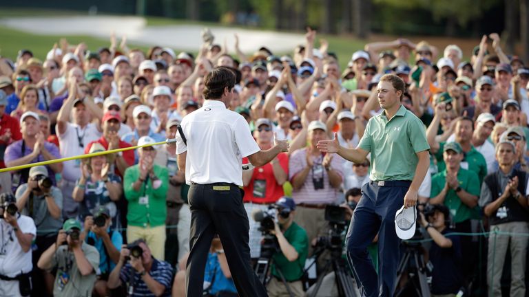 AUGUSTA, GA - APRIL 13:  Bubba Watson of the United States shakes hands with Jordan Spieth on the 18th green after Watson won the 2014 Masters 