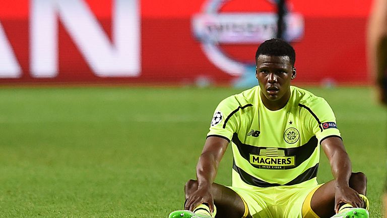 A dejected Dedryck Boyata sits on the pitch after Celtic's loss to Malmo