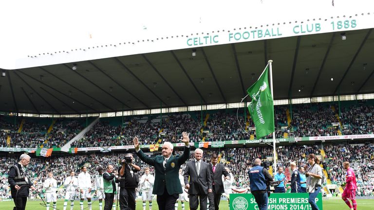 Celtic legend John Clark waves to the fans after unfurling the league flag at Celtic Park. 