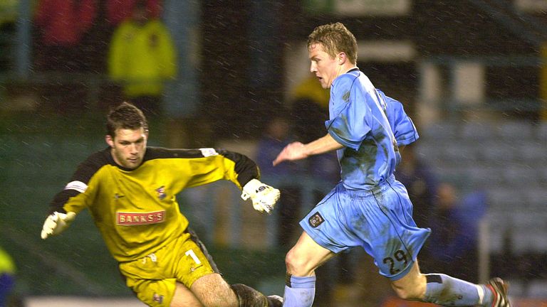 Gary McSheffrey of Coventry gets the ball past James Walker of Walsall