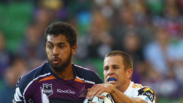 MELBOURNE, AUSTRALIA - MARCH 19:  Dane Nielson of the Storm is tackled during the round two NRL match between the Melbourne Storm and the Gold Coast Titans