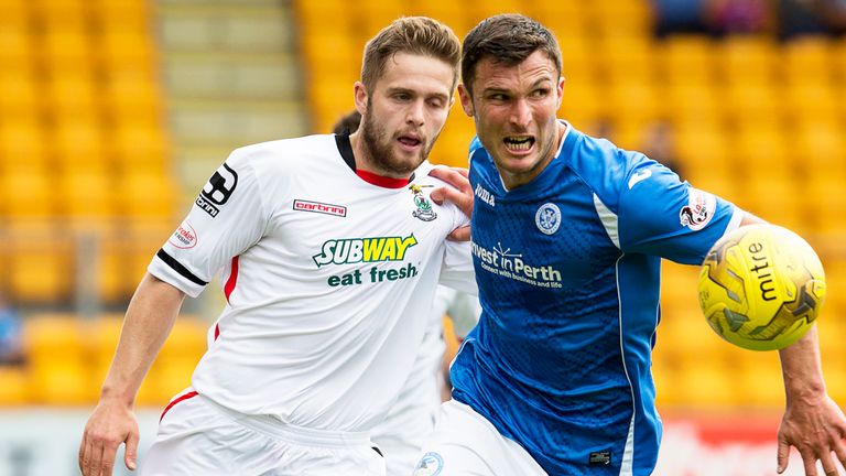 St Johnstone's John Sutton (right) takes the ball away from Daniel Devine (left) 