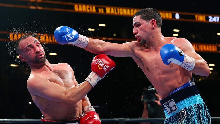 Danny Garcia (R) lands a punch against Paulie Malignaggi during their welterweight bout at Barclays Center in New York