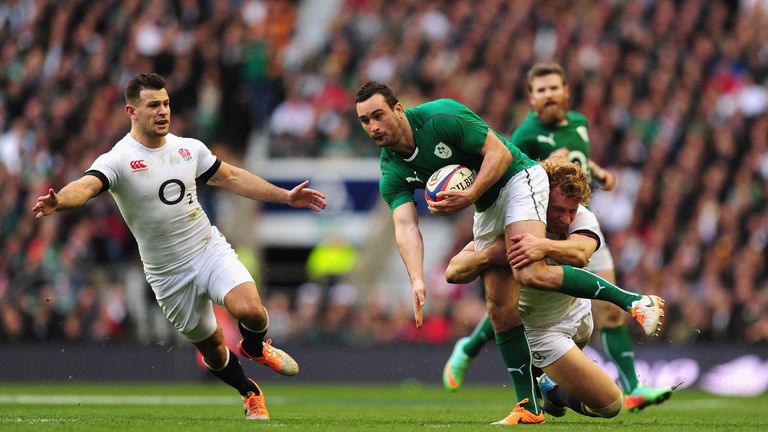 Ireland wing Dave Kearney is tackled by England's Billy Twelvetrees as Danny Care (L) looks on
