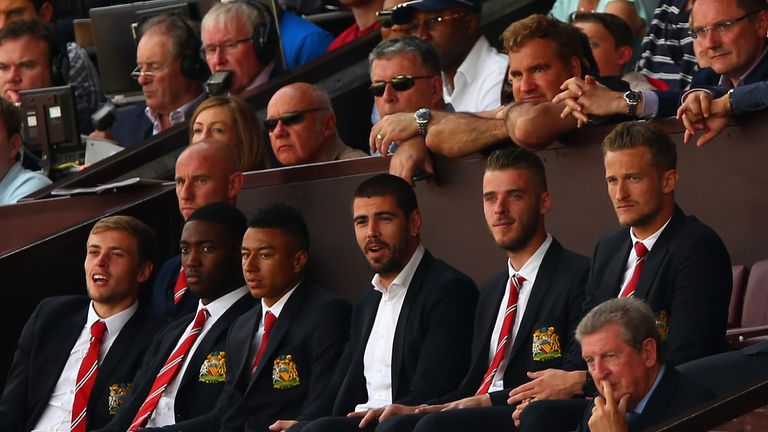 Manchester United players including goalkeepers David de Gea and Victor Valdes watch the game from the stands as Roy Hodgson watches from the row below