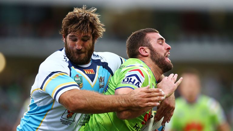 David Taylor (left) of the Titans tackles Mark Nicholls of the Canberra Raiders
