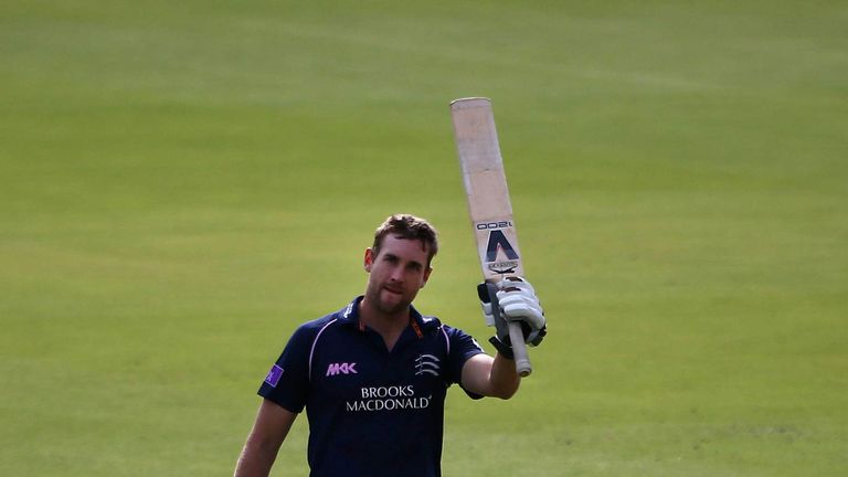 Dawid Malan raises his bat after scoring a century for Middlesex against Glamorgan at Lord's