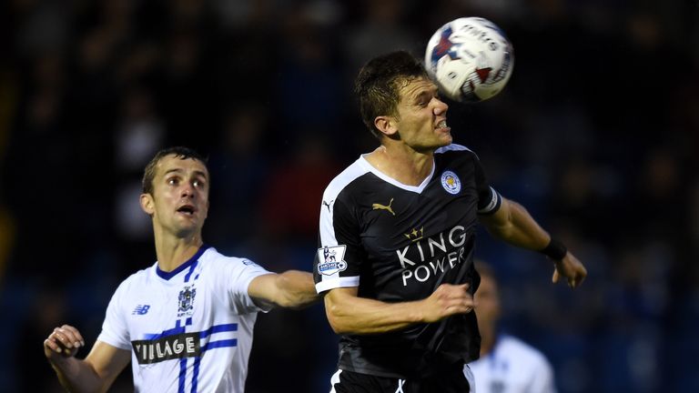 Dean Hammond of Leicester City wins a header with Danny Pugh of Bury during the Capital One Cup second round match