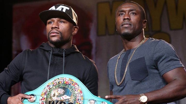 Floyd Mayweather (L) and Andre Berto pose with Mayweather's belt at a press conference ahead of their Las Vegas fight