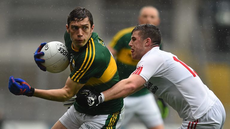 Kerry midfielder David Moran is tackled by Connor McAliskey