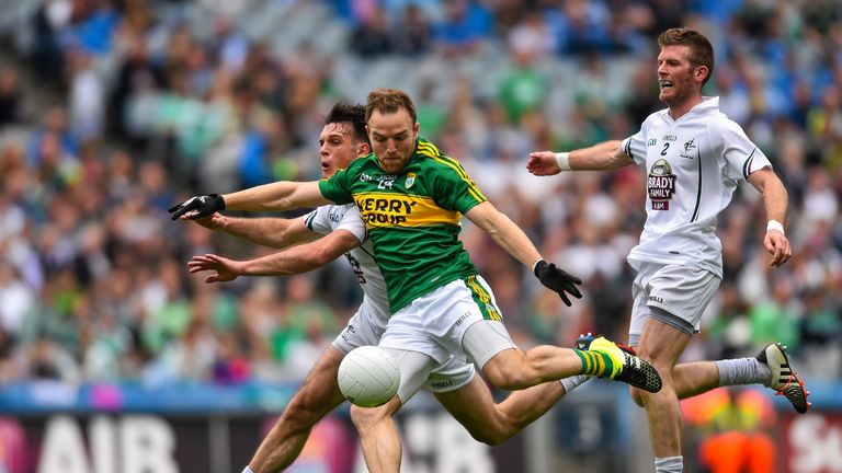 Kerry's Darran O'Sullivan scores his side's third goal despite the tackle by Eoin Doyle of Kildare. 