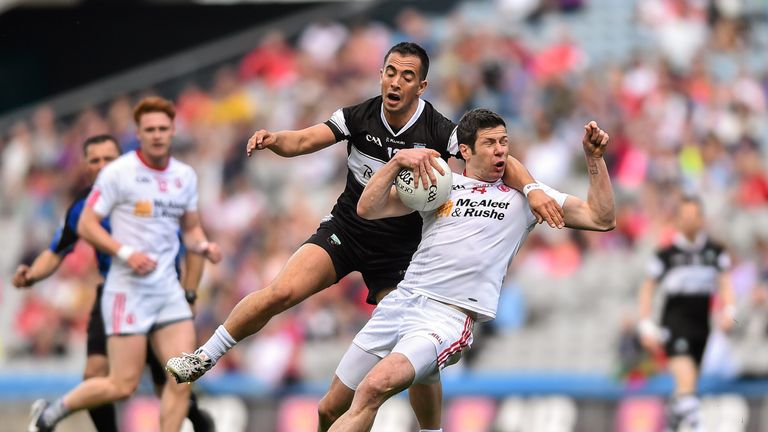 Tyrone captain Sean Cavanagh is tackled by Neil Ewing of Sligo