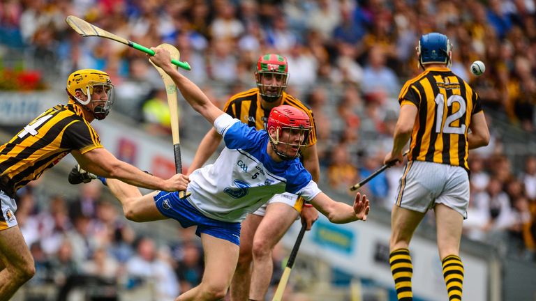 Waterford defender Tadhg de Búrca passes the ball under pressure from Colin Fennelly, Eoin Larkin and TJ Reid