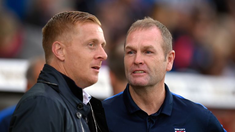 Swansea manager Garry Monk (l) chats with his opposite number Russ Wilcox before the Capital One Cup Second Round match at home to York City
