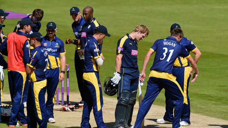 Hampshire batsman Jimmy Adams (3rd right)  looks at the pitch