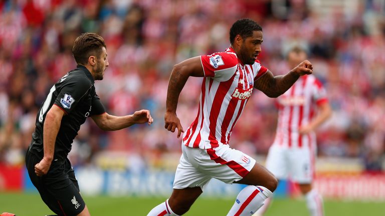 Glen Johnson of Stoke City holds off Adam Lallana of Liverpool during the Barclays Premier League match between Stoke