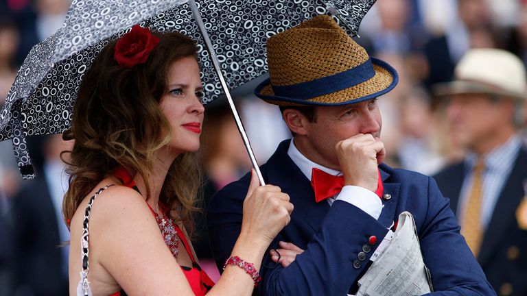 A racegoer nervously bites his nails as he watches the action at Goodwood 