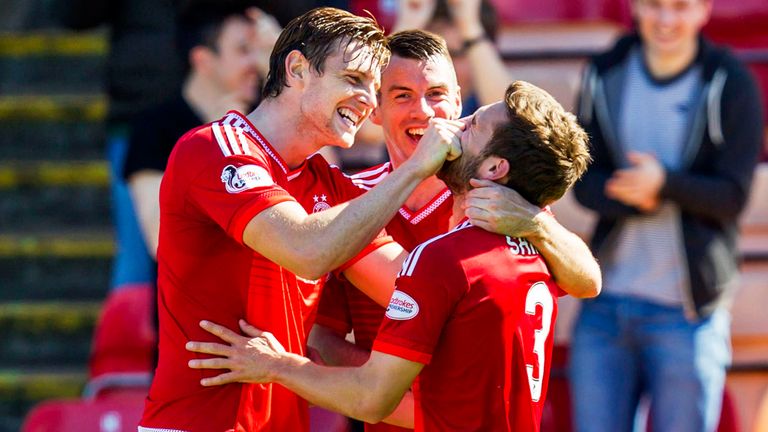 Graeme Shinnie (right) celebrates his opener with Ash Taylor (left) and Paul Quinn.