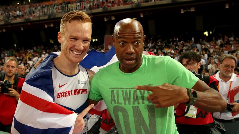 Greg Rutherford of Great Britain (L) is congratulated by Mike Powell