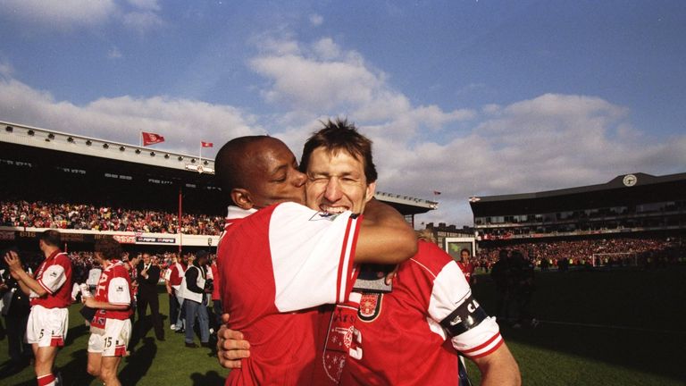 Wright kisses Arsenal captain Tony Adams after winning the Premier League title in 1998