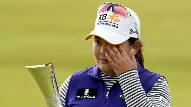 South Korea's Park Inbee wipes away a tear as she celebrates her victory with the trophy after her final round 65