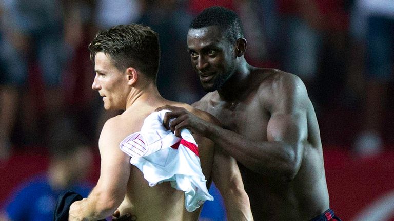 Kevin Gameiro (L) of Sevilla FC changes his t-shirt with Jackson Arley Martinez (R) of Atletico de Madrid 