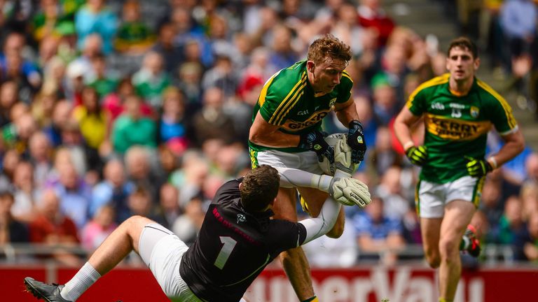 Kerry's James O'Donoghue is tackled by Kildare keeper Mark Donnellan, before leaving the field with an injury. 