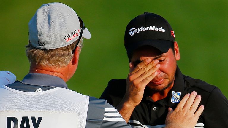 A tearful Jason Day celebrates with his caddie Colin Swatton on the 18th green after winning the 2015 PGA Championship