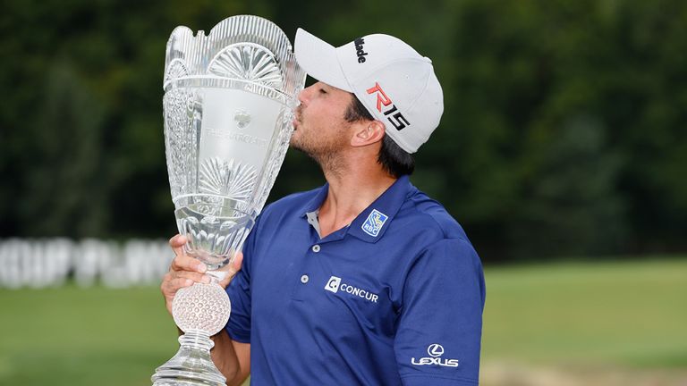  Jason Day of Australia kisses the winner's trophy on the 18th green after his six-stroke victory at The Barclays